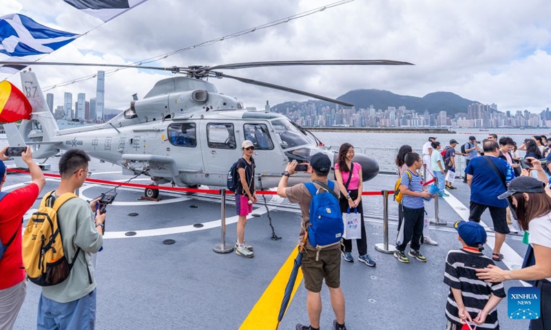People attend an open-house event at the Chinese People's Liberation Army (PLA) Hong Kong Garrison's naval base on Stonecutters Island in south China's Hong Kong, July 4, 2026. A Chinese People's Liberation Army (PLA) Navy fleet opens to Hong Kong and Macao residents and students from Friday through Sunday.