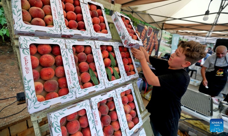This photo taken on July 11, 2026 shows packages of peaches on display at a peach festival in the village of Bikfaya, Mount Lebanon, Lebanon. (Xinhua/Bilal Jawich)