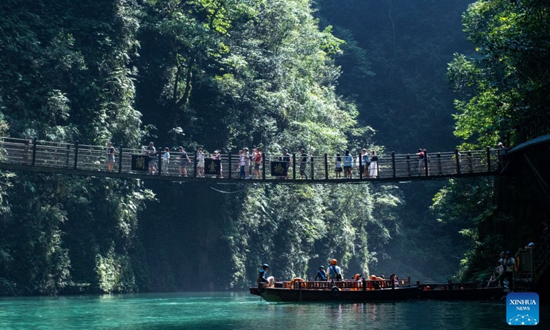 This photo taken on Aug. 16, 2023 shows people visiting a canyon in Enshi, central China's Hubei Province. Hubei, dubbed the province of a thousand of lakes, has done a lot of work in the comprehensive management of its rivers and lakes, in an effort to improve its water ecology and water environment. (Xinhua/Du Zixuan)

