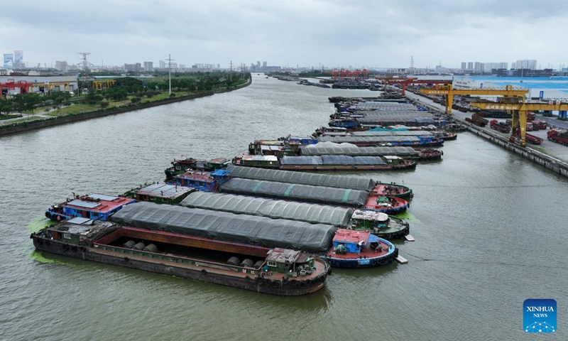 A drone photo taken on July 12, 2026 shows cargo ships anchoring at a harbor to avoid the typhoon in Changzhou City, east China's Jiangsu Province. Typhoon Bavi, the ninth typhoon of the year, landed on the coast of east China's Zhejiang Province at around 11:20 p.m. Saturday, according to the Zhejiang provincial meteorological observatory. (Photo by Chen Wei/Xinhua)