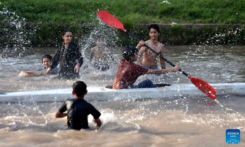 A boy rows a raft during a heat wave in a canal in Lahore, Pakistan on July 4, 2026. (Photo by Sajjad/Xinhua)