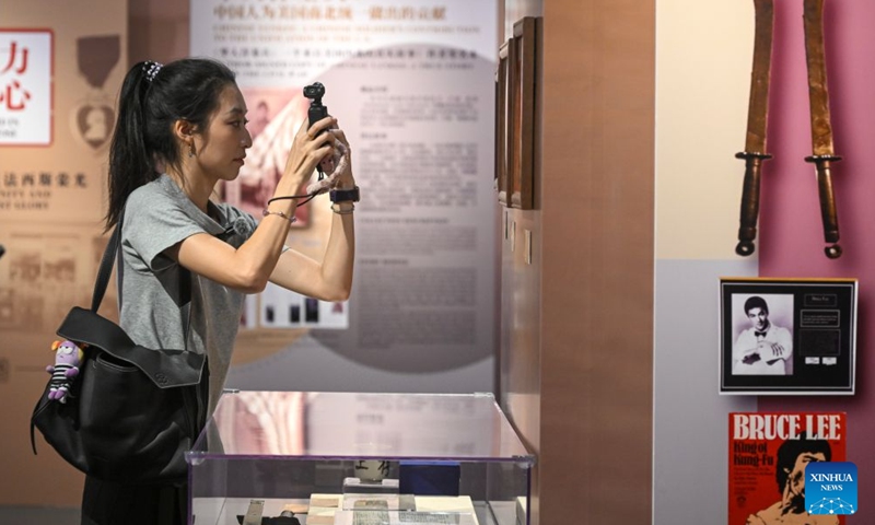 A visitor takes photos during an exhibition in Beijing, capital of China, June 27, 2026. The exhibition highlighting friendly exchanges between the civilian sectors of China and the United States has opened at the Overseas Chinese History Museum of China in Beijing.

