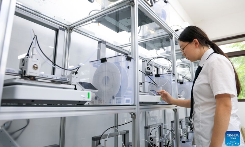 A student operates a 3D printer to prepare for printing during a 3D printing course at a school in Shenzhen, south China's Guangdong Province, June 2, 2026. In recent years, consumer 3D printers have transformed from laboratory niche black technology to popular consumer products, covering different fields from home DIY and campus education to entrepreneurial innovation and large-scale production. (Xinhua/Mao Siqian)

