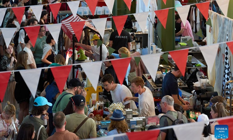 This photo taken on June 20, 2026 shows a scene of the Open Coffee Fest in St. Petersburg, Russia. The fest is held here from June 20 to 21. Baristas from all over Russia demonstrate their skills, attracting many citizens to taste coffee. (Photo by Guo Feizhou/Xinhua)

