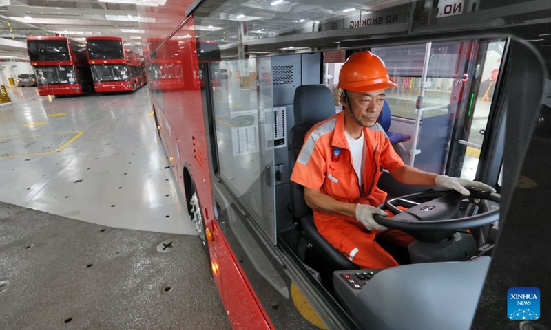 A driver parks a homemade electric double-decker bus on the vehicle deck of a car carrier at Yantai Port in Yantai, east China's Shandong Province, on July 5, 2026.
A total of twenty-two BYD electric double-decker buses on Sunday were shipped from Yantai Port to the United Kingdom. The buses will subsequently be put into service in London's public transport system. (Photo by Tang Ke/Xinhua)