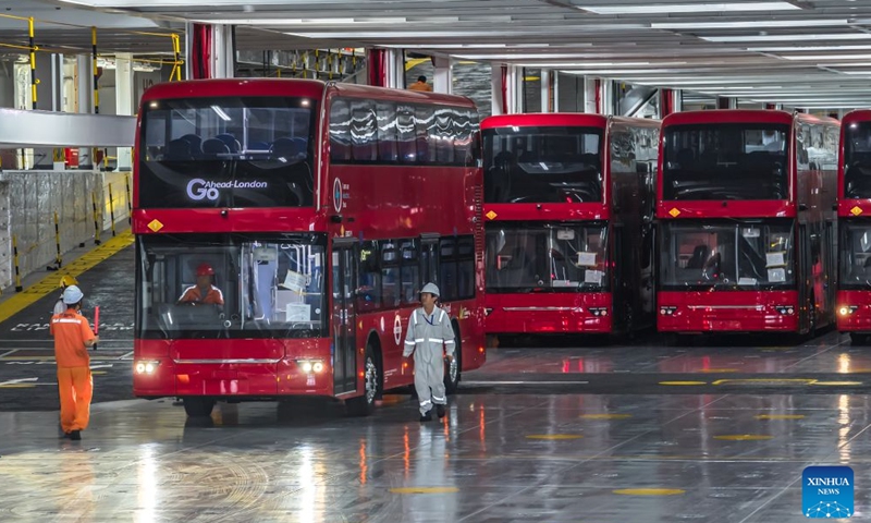 A drone photo taken on July 5, 2026 shows homemade electric double-decker buses being driven onto the vehicle deck of a car carrier at Yantai Port in Yantai, east China's Shandong Province.
A total of twenty-two BYD electric double-decker buses on Sunday were shipped from Yantai Port to the United Kingdom. The buses will subsequently be put into service in London's public transport system. (Photo by Zhang Chao/Xinhua)