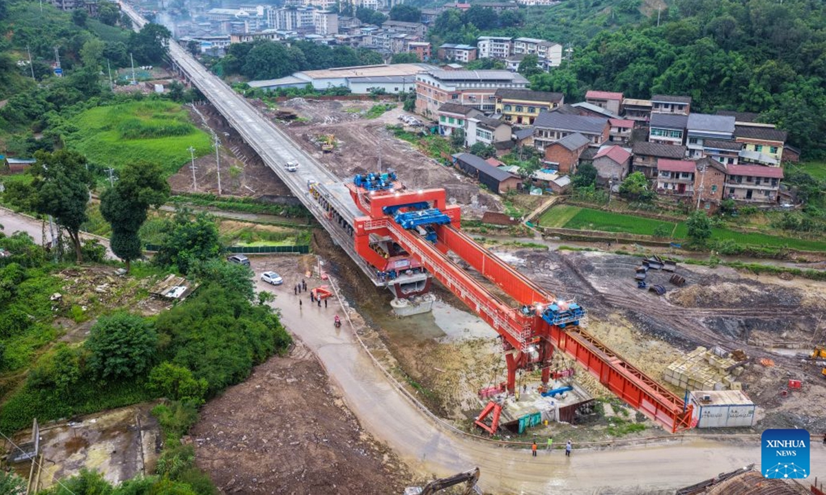 An aerial drone photo taken on June 28, 2026 shows the construction site of the Hechuan East Station grand bridge along the Xi'an-Chongqing High-speed Railway in southwest China's Chongqing Municipality. A 32-meter-long, approximately 700-tonne box girder was installed on the Hechuan East Station grand bridge on Monday, marking the completion of the box girder erection work on the Chongqing section of the Xi'an-Chongqing High-speed Railway. (Xinhua/Tang Yi)

