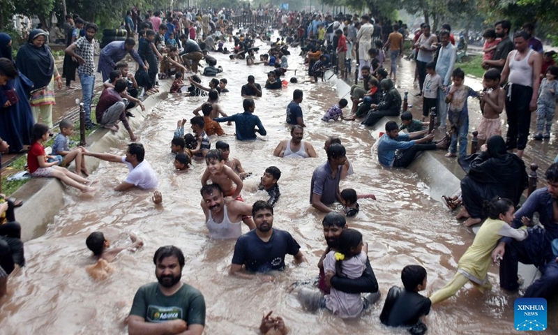 People cool off themselves during a heat wave in a canal in Lahore, Pakistan on July 4, 2026. (Photo by Sajjad/Xinhua)