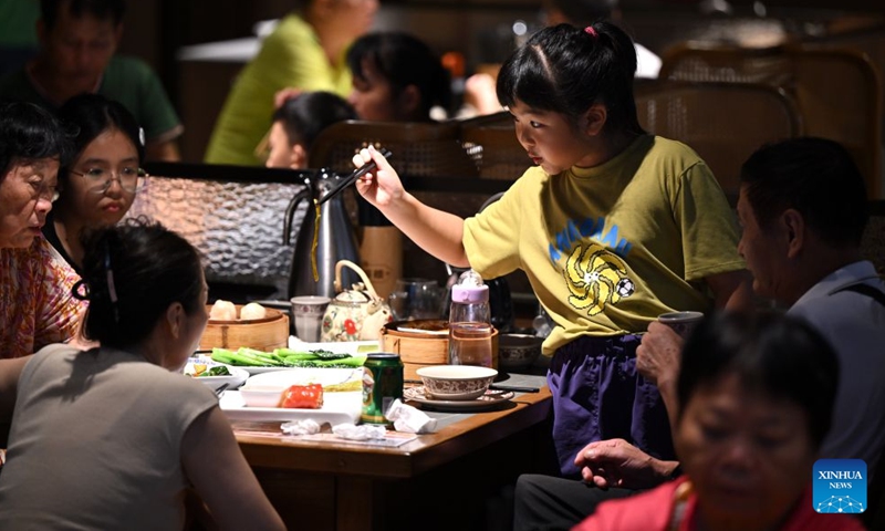 Tourists enjoy Laobacha dishes at a teahouse in Haikou, south China's Hainan Province, July 4, 2026.
Laobacha, or literally old dad tea, refers to a teahouse culture endemic to the island province of Hainan. Offering an array of teas, pastries, and dim sum, Laobacha is a byword for the islanders' relaxed pace of life. (Xinhua/Guo Cheng)