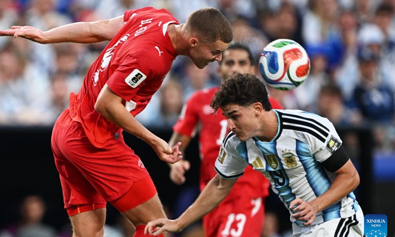 Nico Elvedi (L) of Switzerland vies with Julian Alvarez of Argentina during the quarter final match between Argentina and Switzerland at the 2026 FIFA World Cup at the Kansas City Stadium in Kansas City, the United States, July 11, 2026. (Xinhua/Xiao Yijiu)