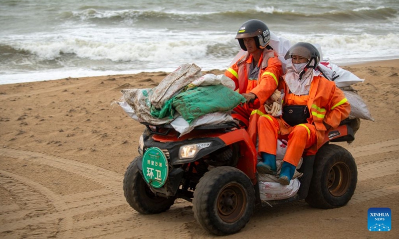 Sanitation workers transport collected debris and garbage washed ashore during a tropical storm landfall on beach in Boao of Qionghai City, south China's Hainan Province, July 4, 2026. The tropical storm came ashore at around 6:20 p.m. in Yelin Township of Lingshui Li Autonomous County, according to the Hainan provincial meteorological bureau. At landfall, it packed maximum winds of 23 meters per second near its center. (Photo by Meng Zhongde/Xinhua)