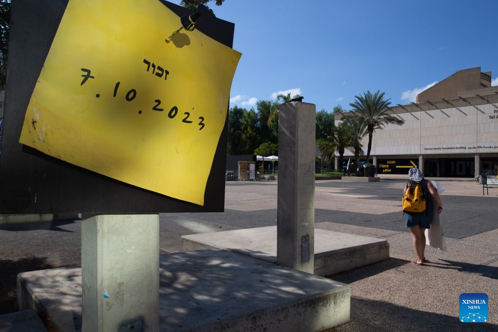 A pedestrian walks past a memorial site for the latest round of Gaza conflict in Tel Aviv, Israel, Oct. 6, 2026. The latest round of Gaza conflict marks its third anniversary on Wednesday. (Xinhua/Chen Junqing)