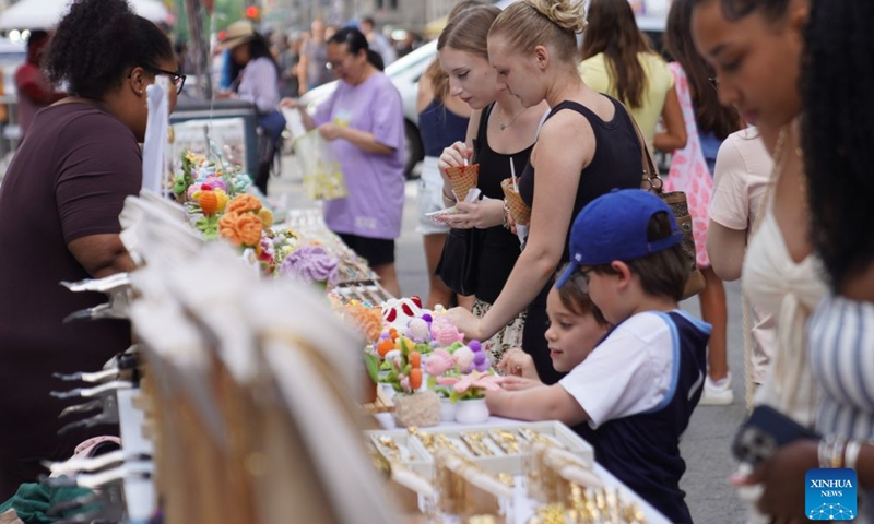 People visit the Avenue of the Americas Summer Expo at middle town of Manhattan in New York, the United States, on June 21, 2026. (Xinhua/Zhang Fengguo)

