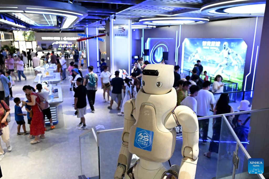 People visit a robot 6S experience store in Qingdao, east China's Shandong Province on Aug. 11, 2026. Recently, the first robot 6S experience store in Qingdao opened, attracting a large number of consumers to visit and experience. This store integrates six major functions including sale, spare parts, service, survey, lease and personalized customization, helping further introducing robots into people's lives. (Xinhua/Li Ziheng)