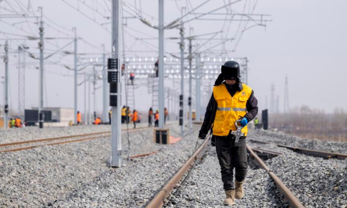 A worker carries out surveying work at the construction site of Suihua South Station of the Harbin-Yichun high-speed railway in Suihua, northeast China's Heilongjiang Province, March 13, 2026.  (Xinhua/Zhang Tao)