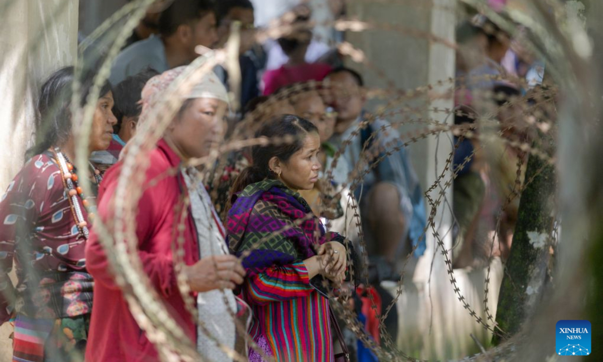 People await news of their missing family members after a massive flash flood in Nuwakot, Nepal, on Aug. 27, 2026. Nepal's National Disaster Risk Reduction Management Authority said that as many as 359 bodies had been recovered from flood-hit areas by Thursday evening, with 910 people still missing. (Photo by Sulav Shrestha/Xinhua)
