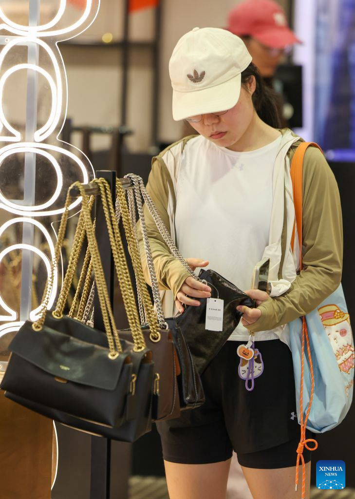 A customer selects goods at a duty-free shop in Haikou, south China's Hainan Province, Oct. 7, 2026. According to Haikou customs, the customs authority supervised offshore duty-free purchases worth 855 million yuan (about 126.8 million U.S. dollars) during the seven-day National Day holiday from Oct. 1 to 7, involving 123,000 shopping visits and 696,800 items. (Xinhua/Yang Guanyu)