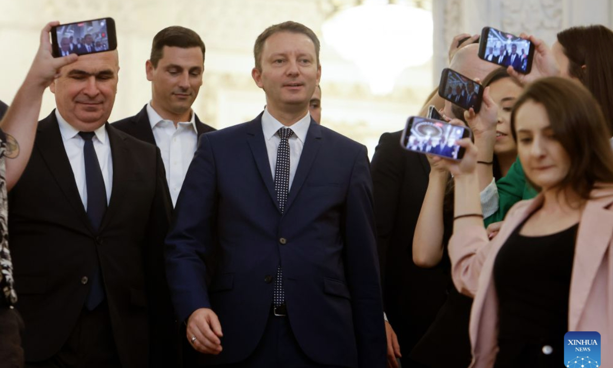 Romania's Prime Minister-designate Siegfried Muresan (C) is pictured at the Parliament Palace in Bucharest, Romania, Sept. 18, 2026. (Photo by Cristian Cristel/Xinhua)