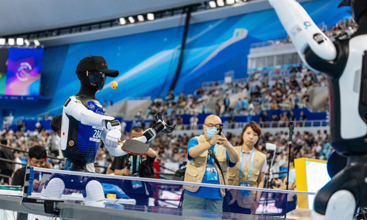 A humanoid robot returns the ball during a table tennis match at the 2nd World Humanoid Robot Games (WHRG) in Beijing on August 23, 2026. Photo: Li Hao/GT