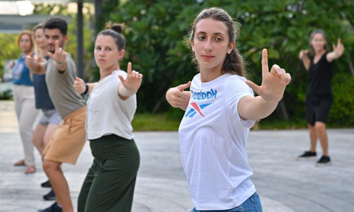 Foreign trainees learn Baduanjin, a traditional breathing and stretching exercise, in Sanya, south China's Hainan Province, Aug. 7, 2025.  (Xinhua/Guo Cheng)