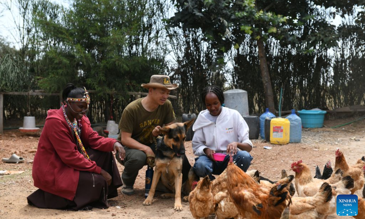 Zhuo Qiang (C) checks the chickens raised by local residents in Narok, Kenya, Aug. 12, 2026. (Xinhua/Liu Qiong)