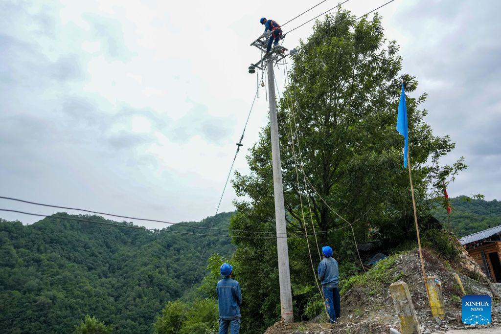 Staff members restore power supply in Fengping Village of Yuhe Town in Longnan, northwest China's Gansu Province, on Aug. 1, 2026. Longnan in northwest China's Gansu Province has activated Level II emergency response for flood control due to widespread heavy rainfall since Wednesday. Authorities at different levels have carried out inspections and assessments for potential hazards and repairs of damaged infrastructure, so as to safeguard people's lives and property. (Xinhua/Lang Bingbing)