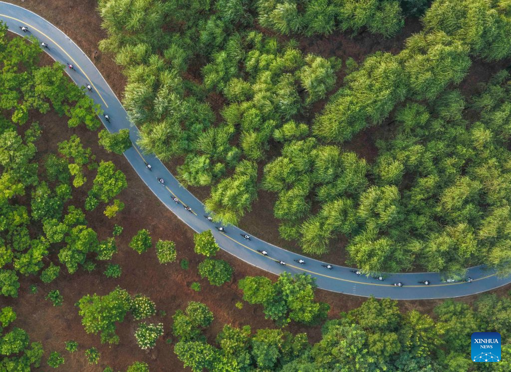 An aerial drone photo taken on Aug. 6, 2026 shows hobbyists riding bikes at a park in Zunhua City, north China's Hebei Province. On the occasion of National Fitness Day, a legacy of the 2008 Beijing Olympics, more people are embracing active lifestyles. (Photo by Liu Mancang/Xinhua)