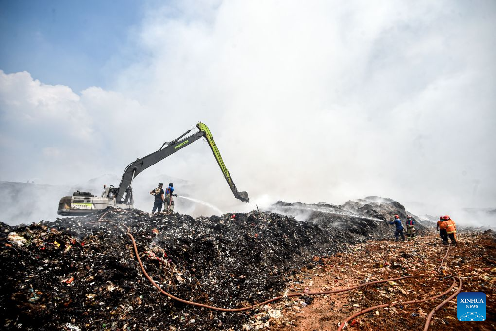 Firefighters attempt to put out a fire at the smoldering landfill in Tangerang Regency, Banten Province, Indonesia, on July 2, 2026. A fire broke out at a landfill in Tangerang regency, near the Indonesian capital city of Jakarta, on Tuesday, scorching more than two hectares of land, local officials said. (Xinhua/Agung Kuncahya B.)