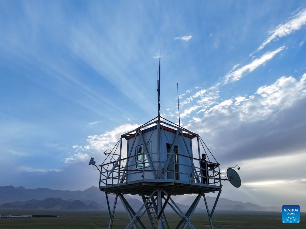 A drone photo taken on Aug. 10, 2026 shows a ranger observing on a watchtower near a management station within the Altun Mountain National Nature Reserve in northwest China's Xinjiang Uygur Autonomous Region. (Xinhua/Hu Huhu)