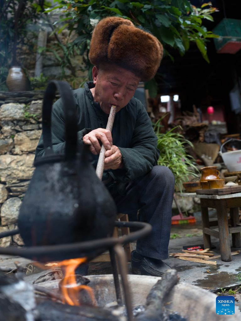 A local resident demonstrates traditional tea processing at his court in Lushi ancient town in Fengqing County of Lincang City in southwest China's Yunnan Province, July 26, 2026. Lushi ancient town in the northeast of Fengqing County lies between the Lancang River and Heihui River. Due to its special geographical location, Lushi was once an important trading hub on the ancient Tea Horse Road, a trade route dating back to the Tang Dynasty (618-907). The town has formed an unique culture that is influenced by merchants coming and going as well as multi-ethnic cohabitation. (Photo by Lan Hongguang/Xinhua)