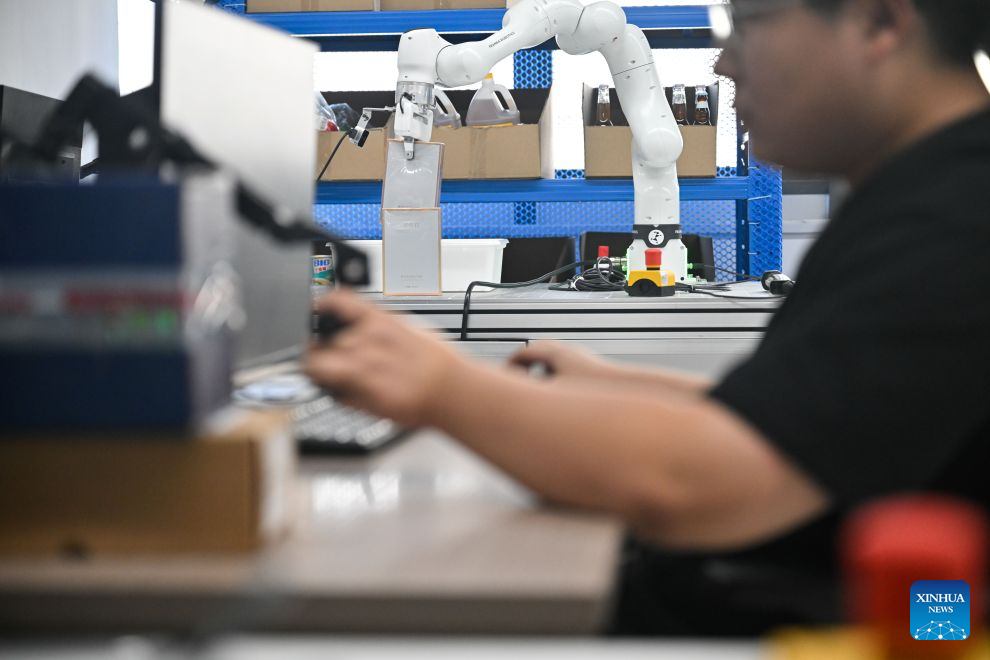 A technician collects data at a robot data collection center of Chinese e-commerce giant JD.com in Suqian, east China's Jiangsu Province, Aug. 24, 2026. In operation since October 2025, JD.com's robot data collection center is a provincial-level embodied intelligent robot data collection center in east China's Jiangsu Province. The facility enhances the data collection scenarios in terms of physical fidelity, generalization ability, and interaction quality. It upgrades the data collection environment to a real physical scene, transforming the data collection center from a static sample library into a training ground for embodied intelligent robots. (Xinhua/Ji Chunpeng)