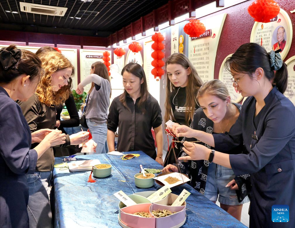 Foreign staff dancers of the Sendi Resort learn to make herbal sachets at the Nantong Museum of Traditional Chinese Medicine Culture in Nantong, east China's Jiangsu Province, Sept. 2, 2026. With their unique charm and outstanding dancing skills, foreign staff dancers have become an attractive part of the Sendi Resort in Nantong. After years of working and living here, they have gradually integrated into local life and fallen in love with the traditional Chinese culture. (Photo by Xu Congjun/Xinhua)