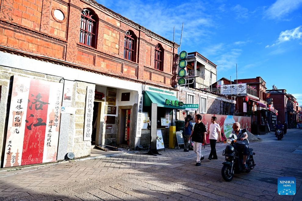 Tourists walk past a museum of qiaopi, letters and remittances sent home by overseas Chinese, on the Qiaonan ancient street in Quanzhou City, southeast China's Fujian Province, Aug. 18, 2026. Qiaonan ancient street in Quanzhou is a historical and cultural block which still preserves traditional Minnan buildings and overseas-Chinese mansions. Minnan literally means southern Fujian Province. In recent years, local government has promoted the protection and utility of this block by rolling out innovative management mode. (Xinhua/Lin Shanchuan)