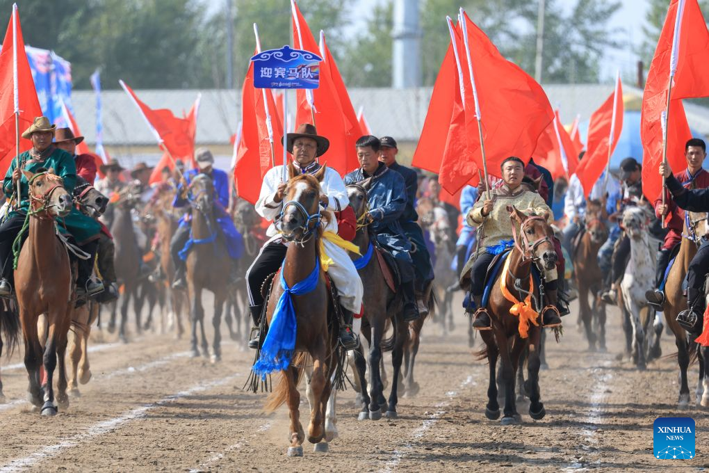 Courtesy horse riders move in formation during the opening ceremony of a Nadam fair in the Mongolian Autonomous County of Dorbod, Daqing City, northeast China's Heilongjiang Province, Sept. 6, 2026. The event was held here on Sunday. It featured cultural performances and folk activities, offering tourists and local residents a celebration of grassland culture. (Photo by Xu Shuai/Xinhua)