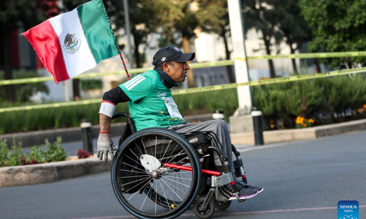 A wheelchair athlete participates in the 43rd edition of the Mexico City Marathon in Mexico City, capital of Mexico, on Aug. 30, 2026. (Photo by Francisco Canedo/Xinhua)