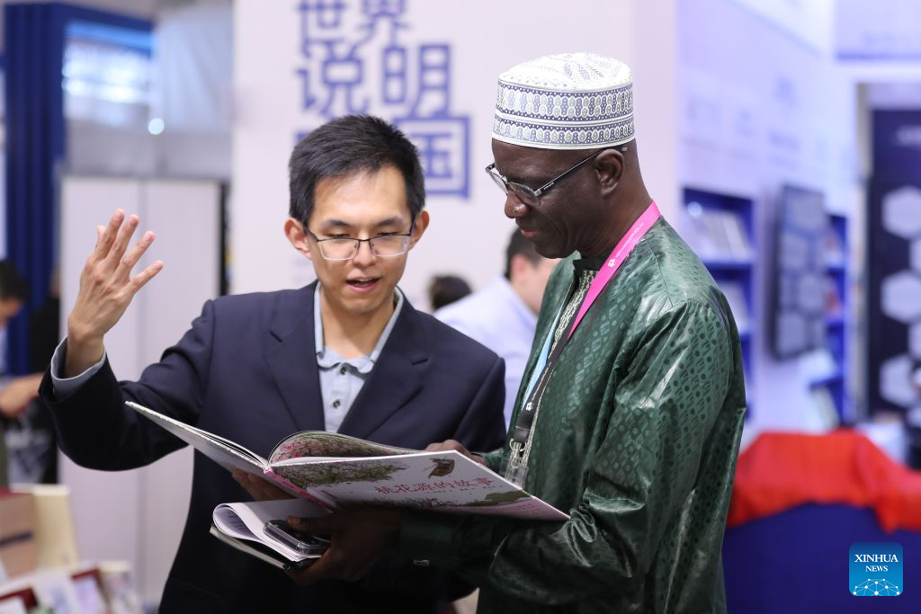 A reader (R) talks to a staff member at the Chinese joint exhibition booth of the Frankfurt Book Fair in Frankfurt, Germany, Oct. 7, 2026. The world's largest book fair opened Wednesday in Frankfurt, Germany, bringing together more than 4,000 publishing institutions from over 100 countries and regions.

The Chinese joint exhibition booth covers 336 square meters and features more than 3,000 titles and over 4,600 copies of selected books. It combines book displays, rights negotiations, cultural exchanges and interactive experiences. (Xinhua/Du Zheyu)