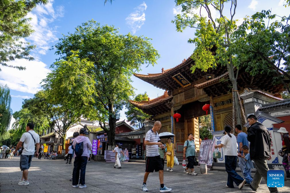 Tourists visit the ancient town of Dali in Dali, southwest China's Yunnan Province, Aug. 22, 2026. The ancient town of Dali has entered its peak tourism season during the summer holiday. According to the ancient town protection and management department, the ancient town recorded over 22 million tourist trips in the first seven months of 2026. (Xinhua/Hu Chao)
