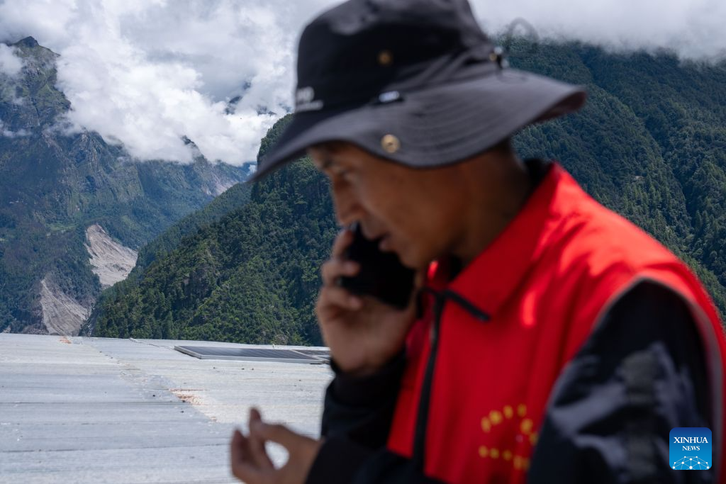 A rescuer makes a phone call to give an update on the rescue in mudslide-affected Gyirong County, southwest China's Xizang Autonomous Region, Sept. 1, 2026. A deadly mudslide, caused by an ice-rock avalanche in Nepal on Aug. 26, 2026, led to interruption of roads, communication and power around the Gyirong Port in Gyirong County. Saleb Township of the county is close to the source of this mudslide disaster, and residents of three villages in the township have been quickly evacuated to safe areas after the disaster.

However, the villagers are worried about their poultry, livestock and farmland. Rescuers from the Saleb Township went to the evacuated villages at regular intervals every day to help the villagers feed their poultry and livestock, patrol the villages, and safeguard their property. (Xinhua/Tenzing Nima Qadhup)