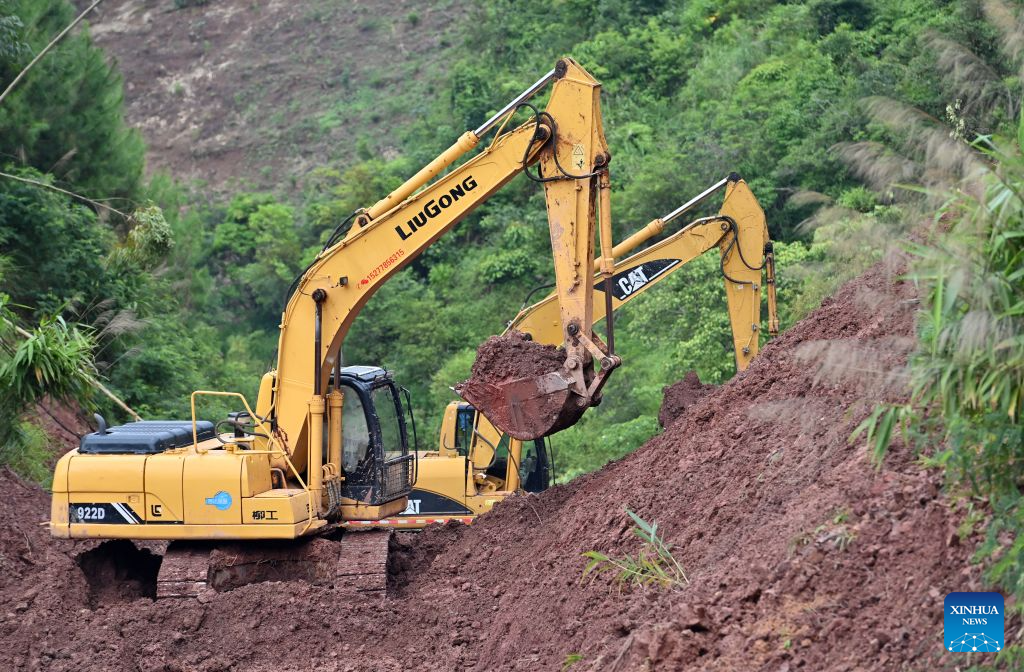 Workers repair a road section interrupted by a landslide in Tongmian Town of Ningming County, Chongzuo City, south China's Guangxi Zhuang Autonomous Region, Aug. 26, 2026. Continuous heavy rainfall caused by Typhoon Narra, the 19th typhoon of the year, has swept across Ningming County. Local authorities have taken every efforts to clear, repair and reinforce the damaged roads and bridges. (Xinhua/Lu Boan)
