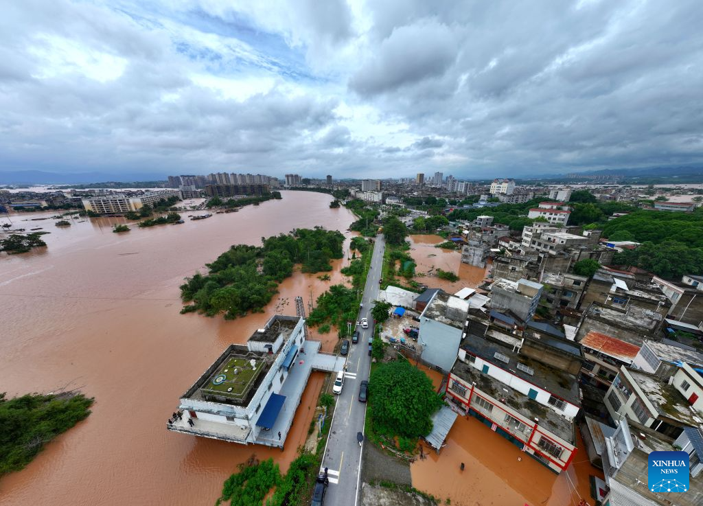 An aerial drone photo taken on Aug. 24, 2026 shows a section of the Mingjiang River in Ningming County, south China's Guangxi Zhuang Autonomous Region. Rescue forces have been deployed in Ningming County where typhoon-triggered heavy rainfall caused flood in the Mingjiang River and its tributaries on Sunday. (Xinhua/Zhou Hua)