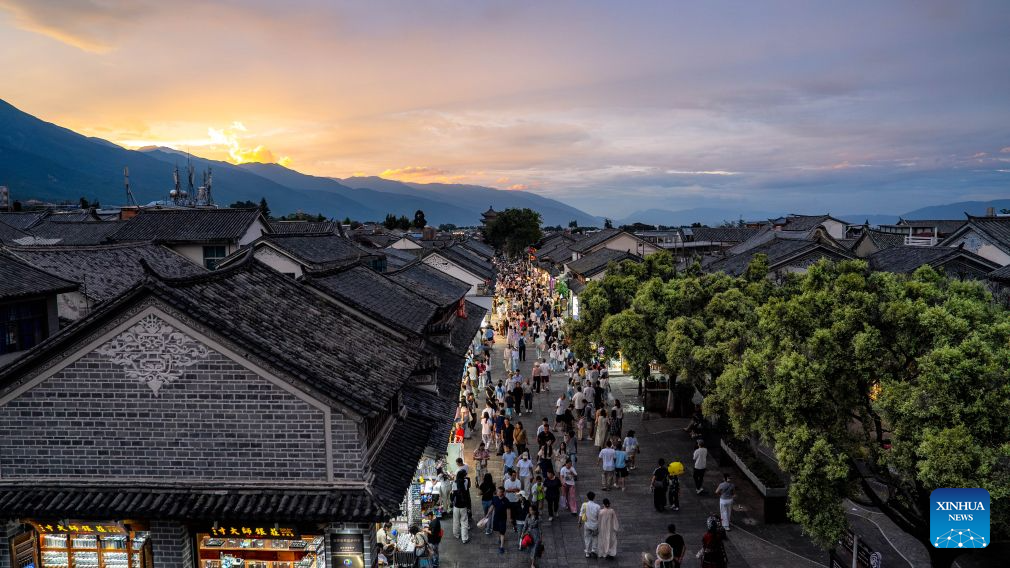 Tourists visit the ancient town of Dali in Dali, southwest China's Yunnan Province, Aug. 22, 2026. The ancient town of Dali has entered its peak tourism season during the summer holiday. According to the ancient town protection and management department, the ancient town recorded over 22 million tourist trips in the first seven months of 2026. (Xinhua/Hu Chao)
