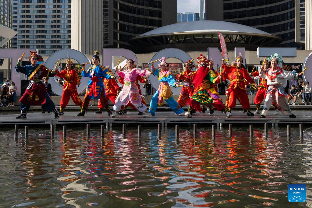 Dressed-up performers present a Yingge dance during the 2026 Toronto Dragon Festival at Nathan Phillips Square in Toronto, Canada, on Sept. 6, 2026. Hosted by the Canadian Association of Chinese Performing Arts (CACPA), this annual event was held here from Friday to Sunday to promote traditional Chinese culture through performing arts and related activities. (Photo by Zou Zheng/Xinhua)