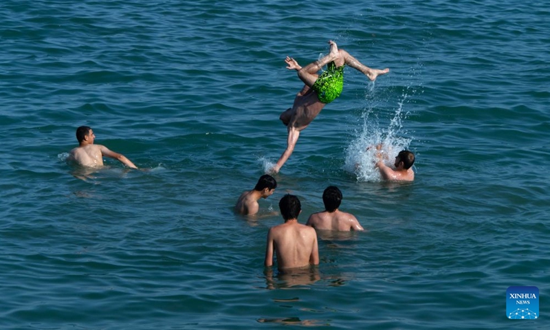 People have fun in the Caspian Sea in Baku, Azerbaijan, June 20, 2026. The temperature in Baku hit 33 degrees Celsius in the afternoon on June 20. Shikhov Beach in Baku attracted numerous locals and tourists for swimming and leisure. (Xinhua/Chen Junfeng)
