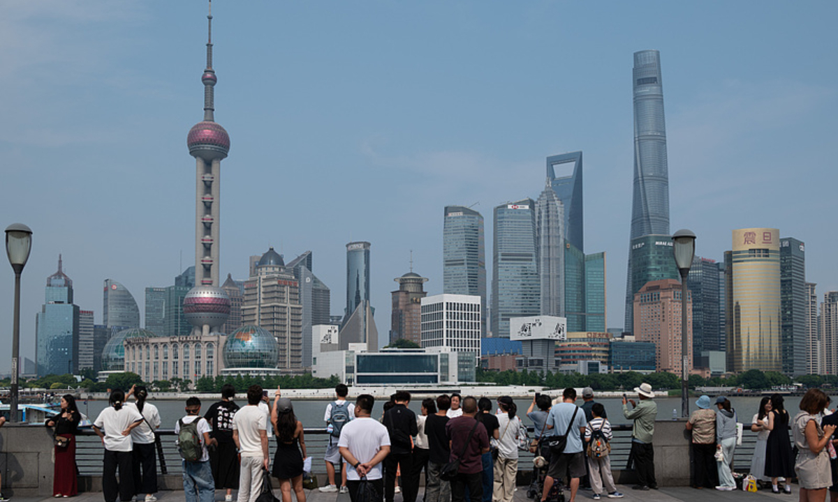 Tourists visit the Bund, Shanghai on June 25 Photo: VCG