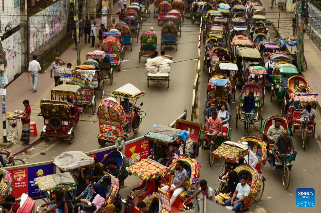 This photo taken on Aug. 22, 2026 shows rickshaws on a street in Dhaka, Bangladesh. In 2023, UNESCO announced the inclusion of Bangladesh's iconic rickshaws and rickshaw painting in Dhaka on the Representative List of the Intangible Cultural Heritage of Humanity. (Photo by Habibur Rahman/Xinhua)