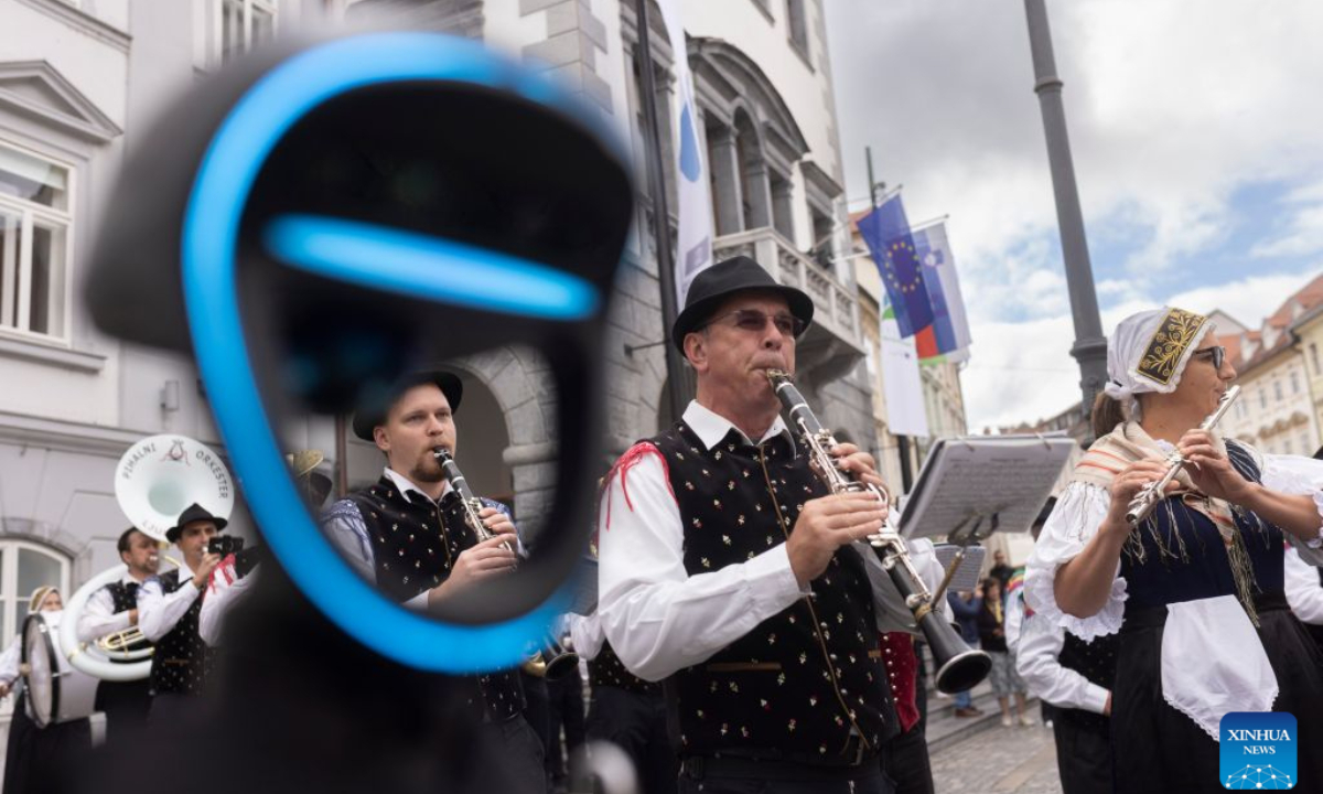 A Unitree G1 humanoid robot conducts the Ljubljana Wind Orchestra during the parade of the Ljubljana Wind Orchestra in Ljubljana, Slovenia, Oct. 11, 2026. (Photo by Zeljko Stevanic/Xinhua)