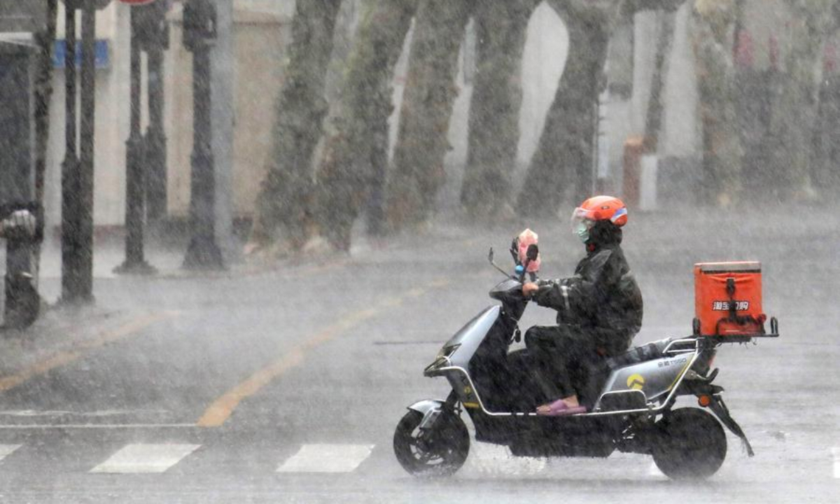 A delivery rider rides a motorcycle in the rain in Suzhou, east China's Jiangsu Province, Aug. 10, 2026. (Photo by Hang Xingwei/Xinhua)
