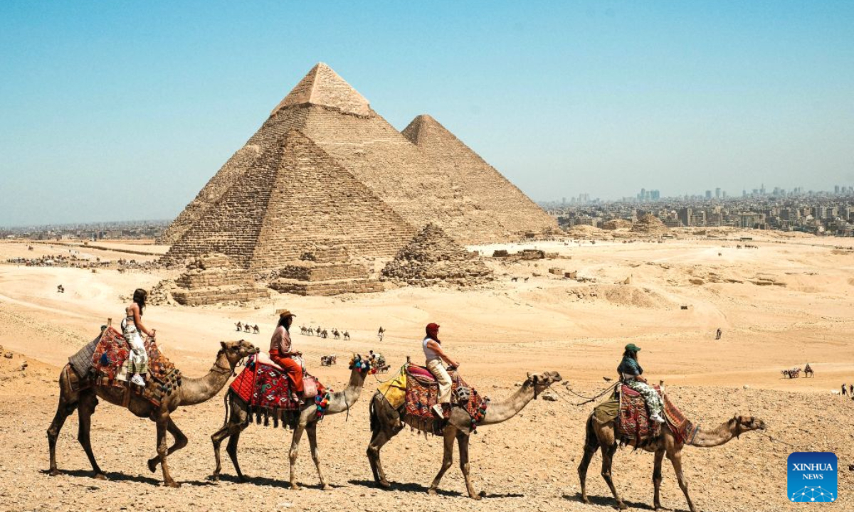 Tourists ride camels at the Giza pyramid complex in Egypt, April 9, 2026. Egypt is home to an ancient civilization that flourished along the Nile River. From the pyramids that have stood for millennia to its bustling modern cities, the ancient and the contemporary intertwine across the country, reflecting a civilization that has endured through the ages. (Xinhua/Xin Mengchen)