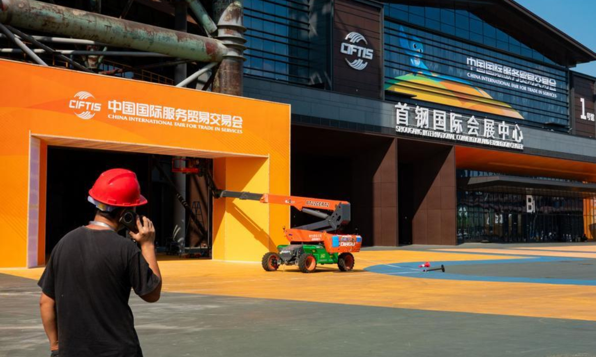 A worker is pictured in front of the Shougang International Convention and Exhibition Center at the Shougang Park in Beijing, capital of China on Sept. 2, 2026. (Xinhua/Zhang Xiaoyu)