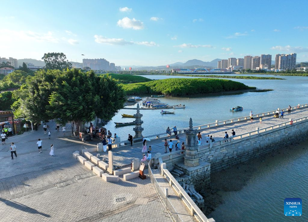 An aerial drone photo taken on Aug. 18, 2026 shows tourists visiting Luoyang Bridge in Quanzhou, southeast China's Fujian Province. Luoyang Bridge, also known as Wan'an Bridge, is a component of the UNESCO World Heritage site Quanzhou: Emporium of the World in Song-Yuan China.
In recent years, Quanzhou has woven cultural heritage into daily life by introducing intangible cultural heritage programs and cultural and creative businesses, attracting more tourists to the area. (Xinhua/Lin Shanchuan)